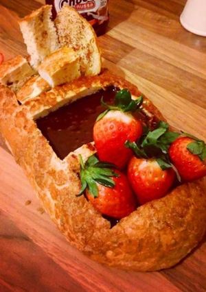 A picture of Chocolate fondue breadboat with strawberry.