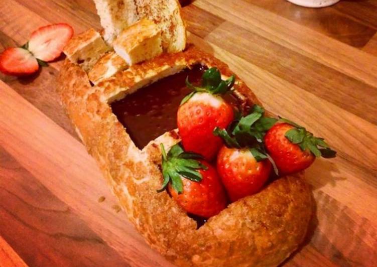 Chocolate fondue breadboat with strawberry
