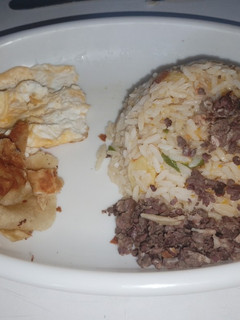 A picture of Eggs, rice and samosa.