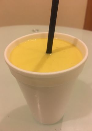 A picture of Mango Lassi   (sweetened mango-yogurt drink).