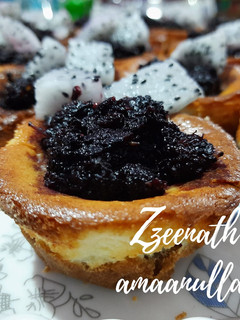 A picture of Baked Mini Cheesecake Cups with Black Mulberry Compote.