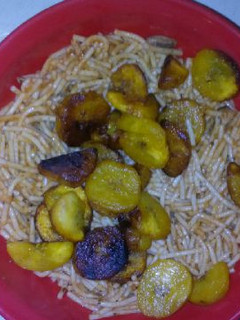 A picture of Spagetti with fried plantain.