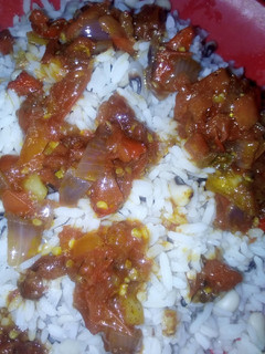 A picture of Rice and beans with peppered sauce.
