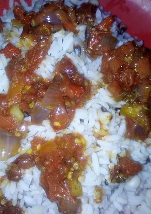 A picture of Rice and beans with peppered sauce.
