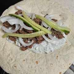 A picture of Ground Beef Gyros with Tzatziki.