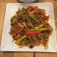 A picture of Seafood mix on fried veggies.