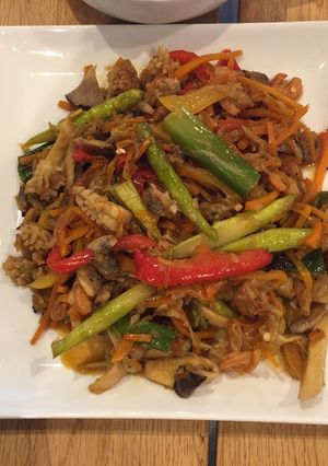 A picture of Seafood mix on fried veggies.