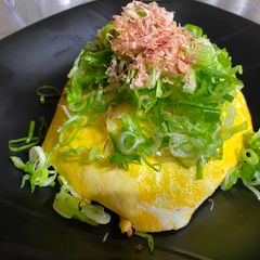 A picture of Omu-Okonomiyaki (Japanese as-you-like pancake wrapped with egg).