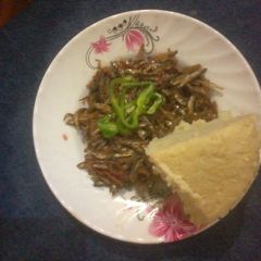 A picture of Plain Fried omena with yellow ugali.