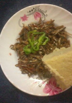 A picture of Plain Fried omena with yellow ugali.