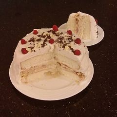 A picture of White Layer Cake with a Raspberry Swirl Cheesecake center layer and a Raspberry Cream Frosting.