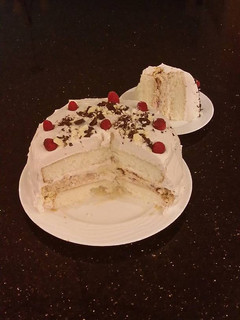 A picture of White Layer Cake with a Raspberry Swirl Cheesecake center layer and a Raspberry Cream Frosting.