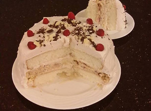 A picture of White Layer Cake with a Raspberry Swirl Cheesecake center layer and a Raspberry Cream Frosting.
