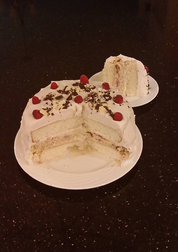 A picture of White Layer Cake with a Raspberry Swirl Cheesecake center layer and a Raspberry Cream Frosting.