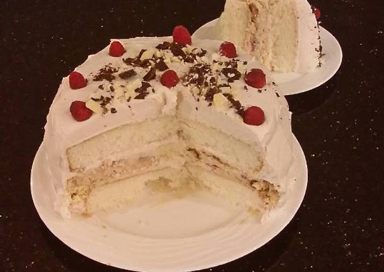 White Layer Cake with a Raspberry Swirl Cheesecake center layer and a Raspberry Cream Frosting