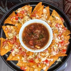 A picture of Easy Cheesy nachos with salsa dip.