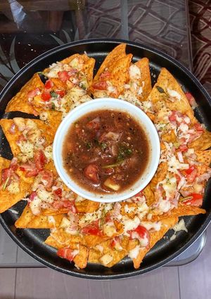 A picture of Easy Cheesy nachos with salsa dip.
