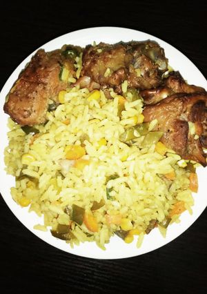A picture of Fried rice and chicken.
