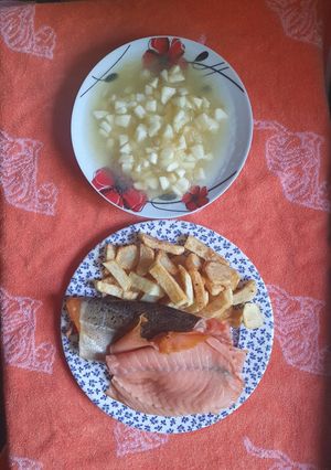 A picture of Smoked Salmon and chips with Apple Sauce.