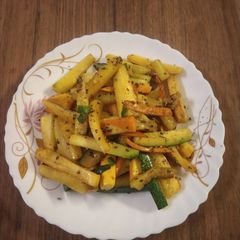 A picture of Zucchini and carrot stir fry.
