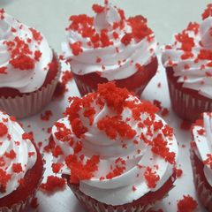 A picture of Red cup cakes with chocolate center.