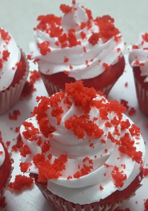 A picture of Red cup cakes with chocolate center.