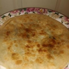 A picture of Alu paratha with desi ghee.