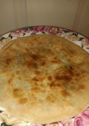 A picture of Alu paratha with desi ghee.