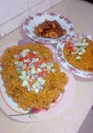 A picture of Jollop rice and beans with fried plantain.