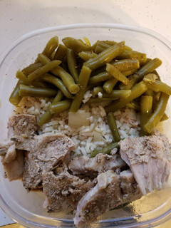 A picture of Caribbean jerk pork with rice and green beans in crock pot.