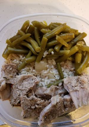 A picture of Caribbean jerk pork with rice and green beans in crock pot.