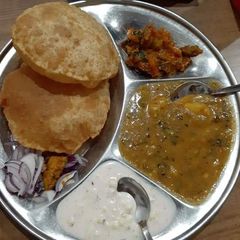 A picture of Aloo ki sbzi with puri.