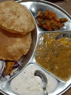 A picture of Aloo ki sbzi with puri.