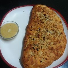 A picture of Garlic Bread with Cheese Dip.