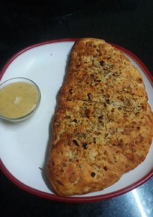 A picture of Garlic Bread with Cheese Dip.