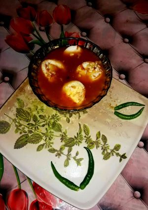 A picture of Veg clear soup with sliced boiled egg.