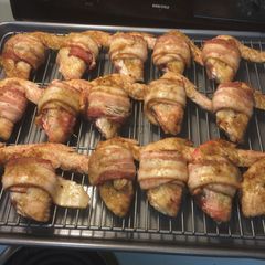 A picture of Chicken wings with bacon.