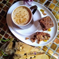 A picture of Oat meal cake with frothy coffee...