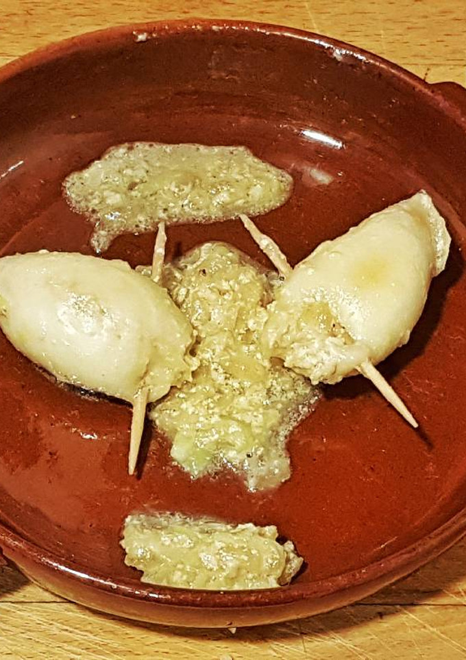 Una foto de Chipirones rellenos con salsa de puerros y cebolla