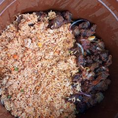 A picture of Pepper goat meat & jollof rice.