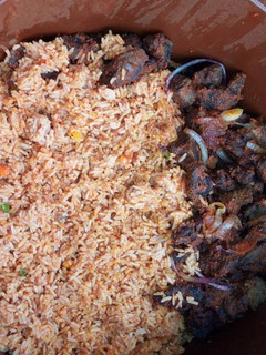 A picture of Pepper goat meat & jollof rice.