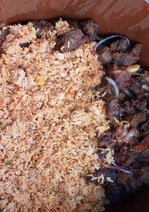A picture of Pepper goat meat & jollof rice.
