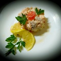 A picture of Salmon tartare with diet cheeses, lemon, olive oil.