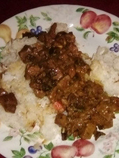 A picture of Beef tips with mushrooms over rice.