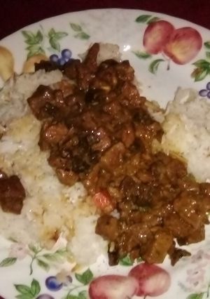 A picture of Beef tips with mushrooms over rice.