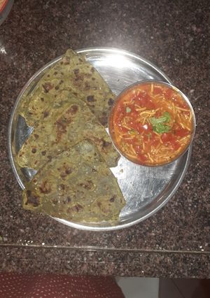 A picture of Spinach mint paratha with sev tomato sabji.