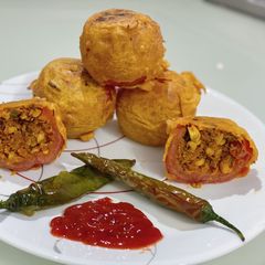 A picture of Stuffed tomato bonda.
