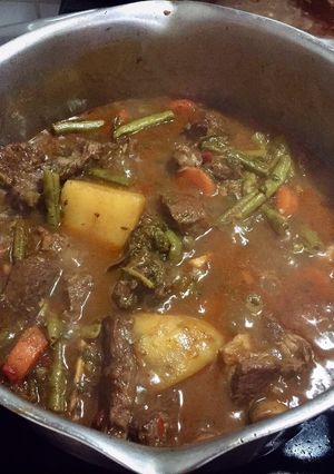 Una foto de Côte de boeuf avec légumes et vin
