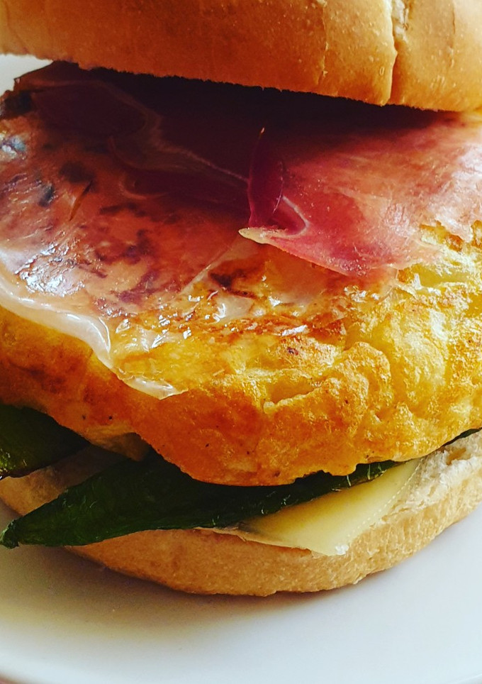 Una foto de Tortilla burger con ajo y pimiento frito (burger a la española)