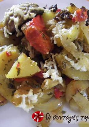 A picture of Potatoes in the oven with mushrooms.